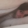 woman in bed under blanket