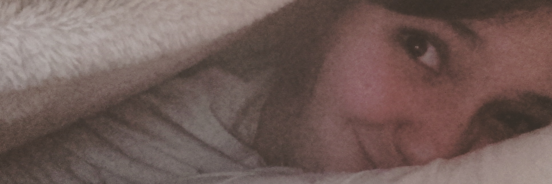 woman in bed under blanket