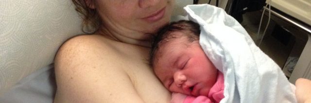 Mother holding baby in hospital after birth