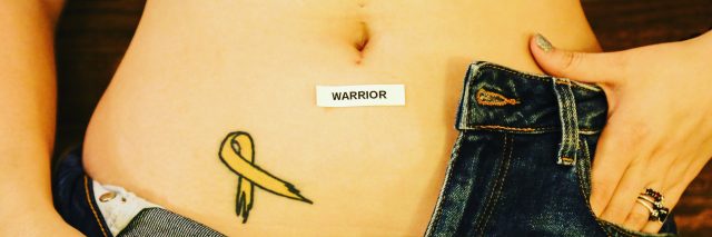 A woman shows her endometriosis tattoo, along with a sticker that reads, "Warrior."