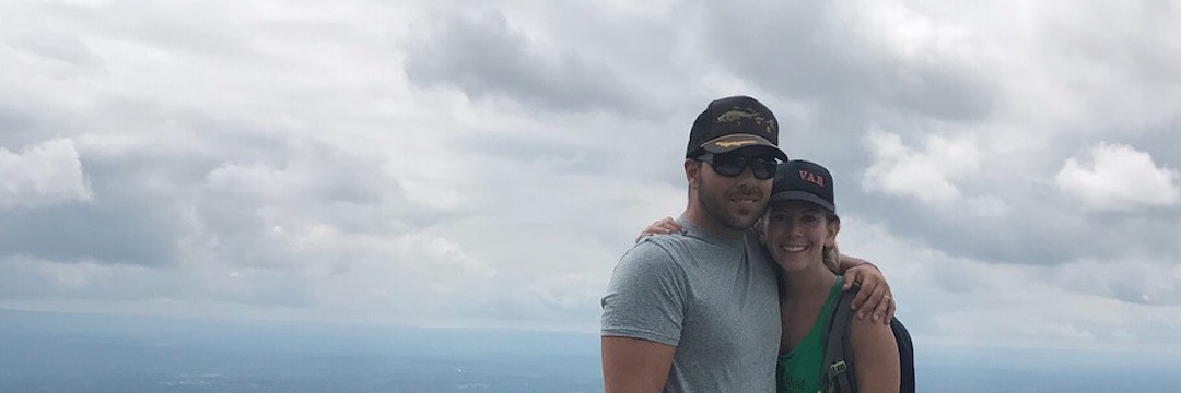 Struggling to Accept My Lupus Diagnosis woman hiking a mountain with her husband and dog