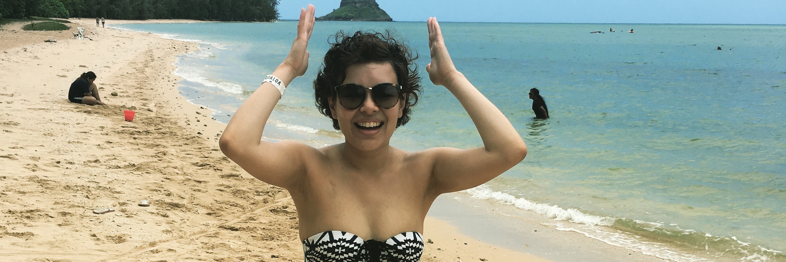 The Day I Showed Off My Scars and Insecurities in a Bikini woman in a bikini standing on the beach and laughing