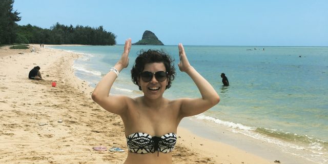 The Day I Showed Off My Scars and Insecurities in a Bikini woman in a bikini standing on the beach and laughing