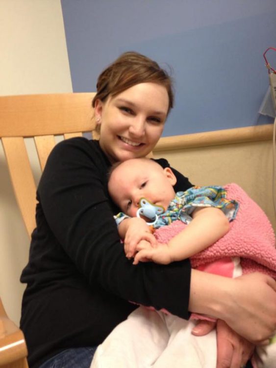 mom holding daughter in hospital bed