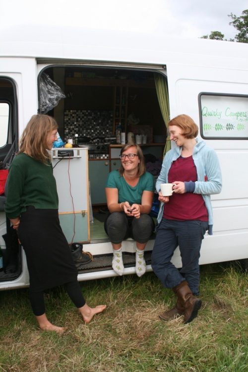 friends hanging out and talking around the quirky campers van