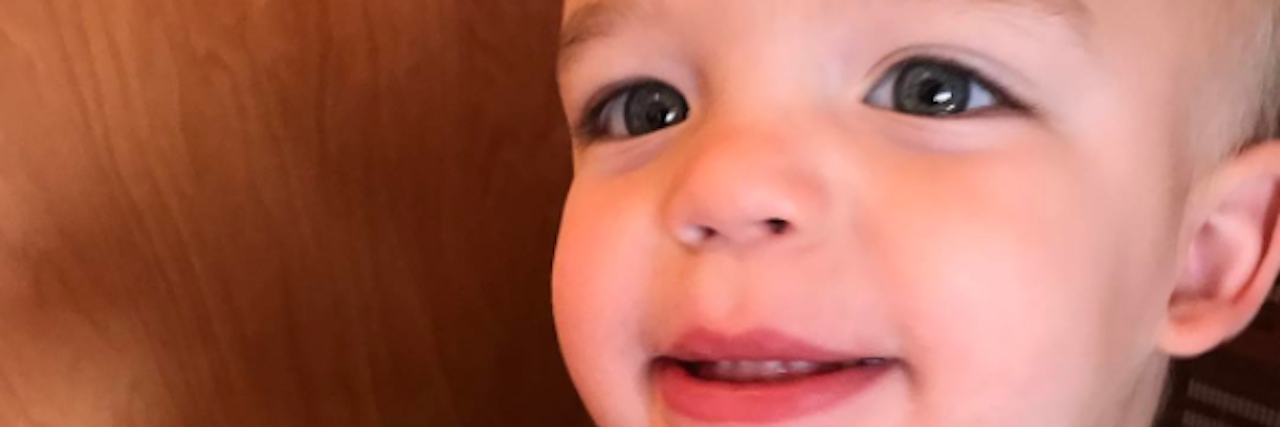 Feeling Stuck In Between as a Mom to a Boy With Neurofibromatosis little boy eating a bagel