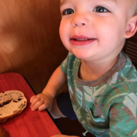 little boy eating a bagel