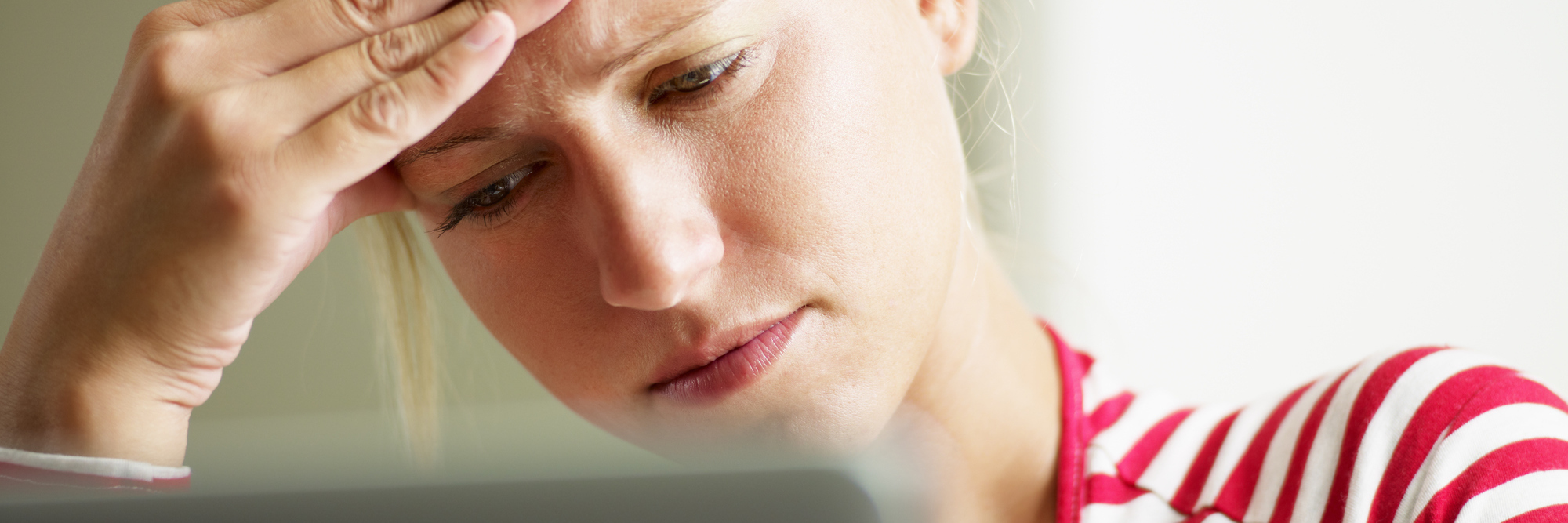 What Not to Say to Someone With Invisible Illnesses woman reading something on her computer and looking annoyed