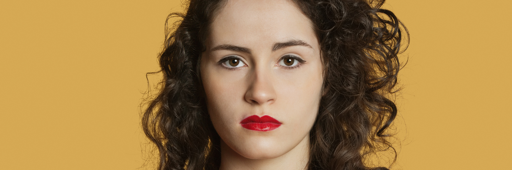 What I Really Need You to Understand About Life With Crohn's Photo of a woman with dark hair looking into the camera with a serious expression.