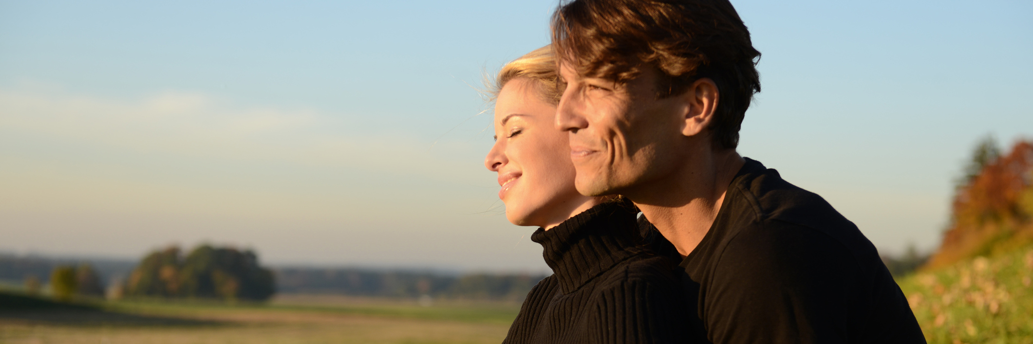 Having My Husband's Support During Journey With Multiple Sclerosis couple sitting together outside in a field and laughing