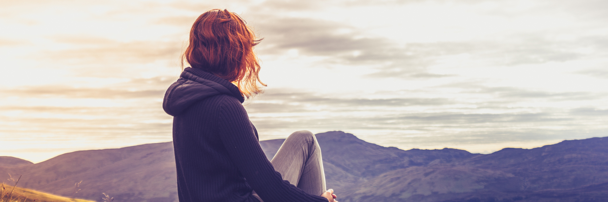 What It's Like to Not Die From Breast Cancer, Yet Woman admiring sunset from mountain top