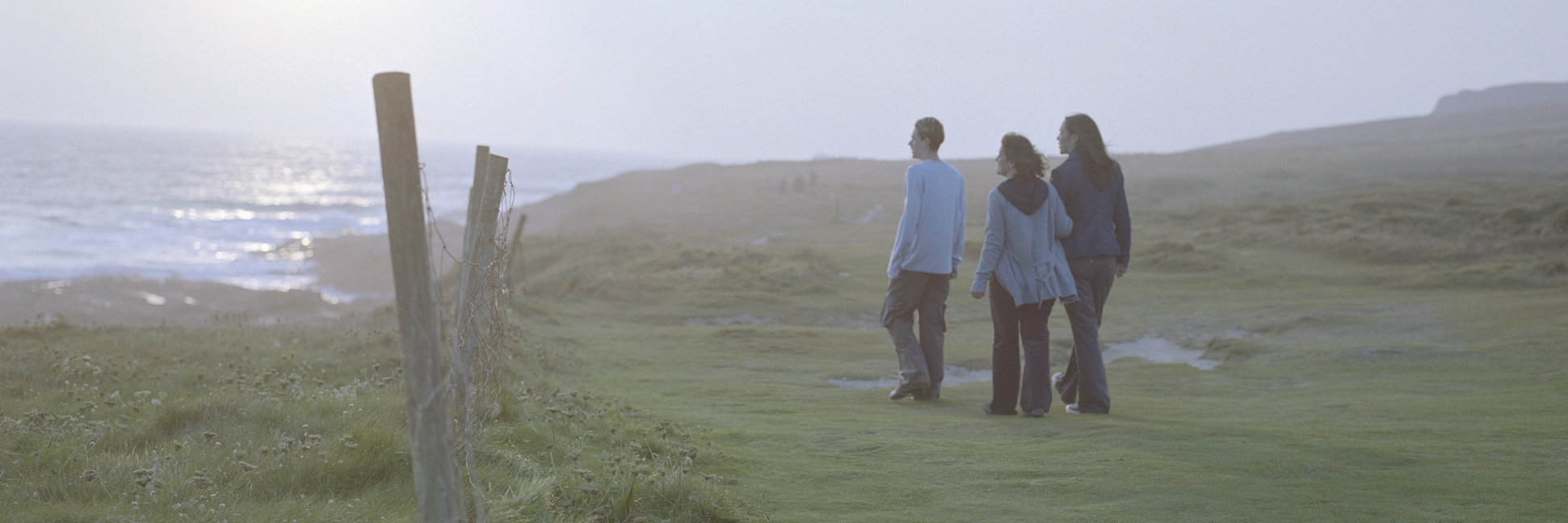 To the Parents of Someone Struggling With an Eating Disorder Woman with son and daughter (15-17) on grass by sea, rear view