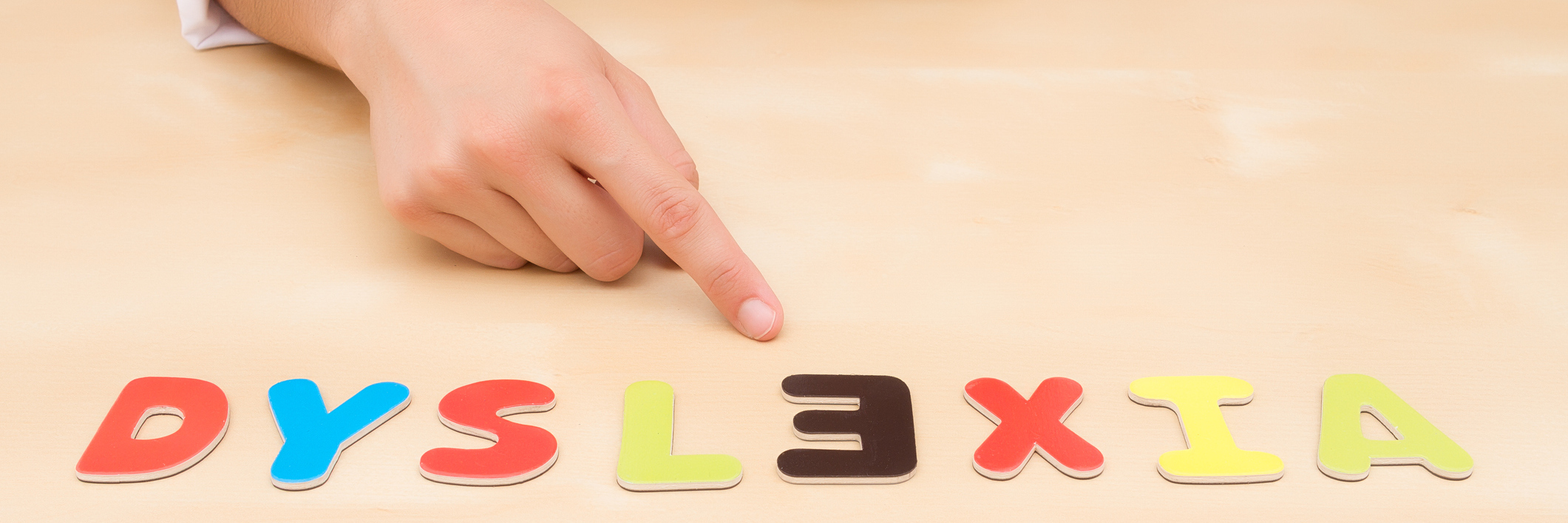 Dyslexia letters spelled out on a table with the E backwards.