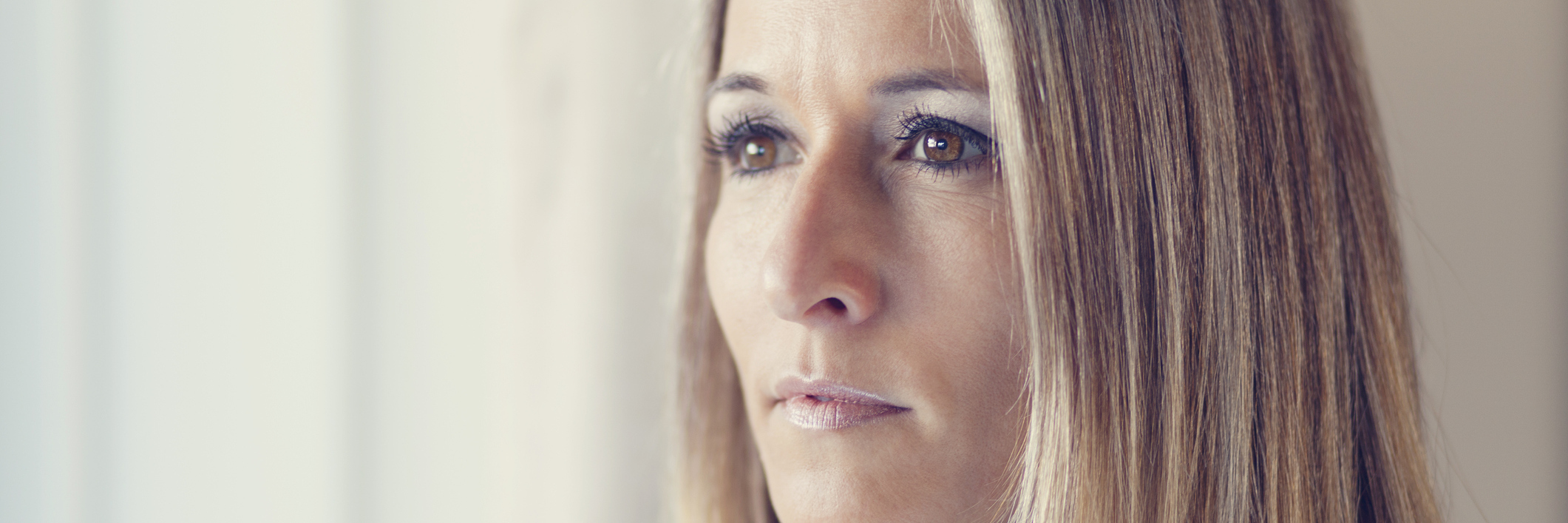 My Struggle as a Parent With Depression sad blonde woman looking out window