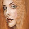 painting of a woman's face on wood