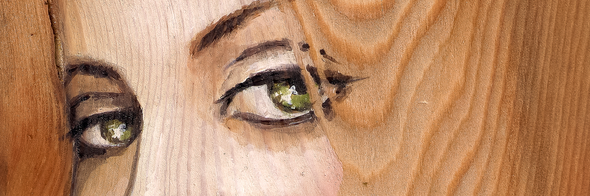 painting of a woman's face on wood