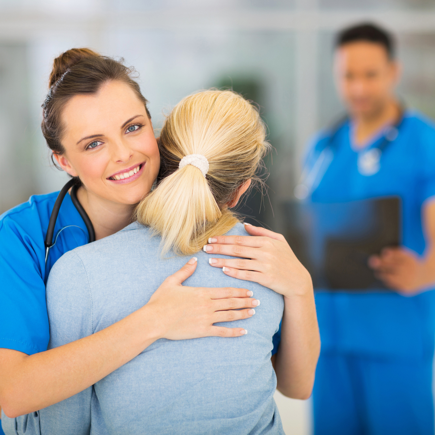 nurse hugging her patient