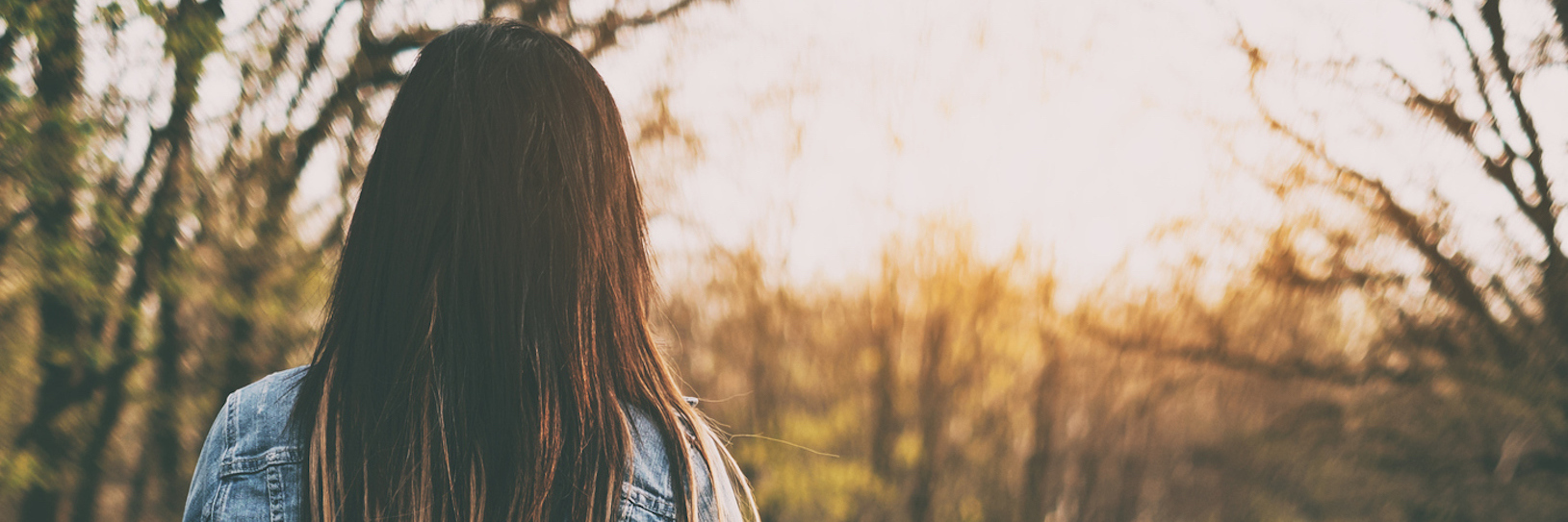 Searching for the Reasons Why I Have Chronic Pain Brunette woman walking the forest road