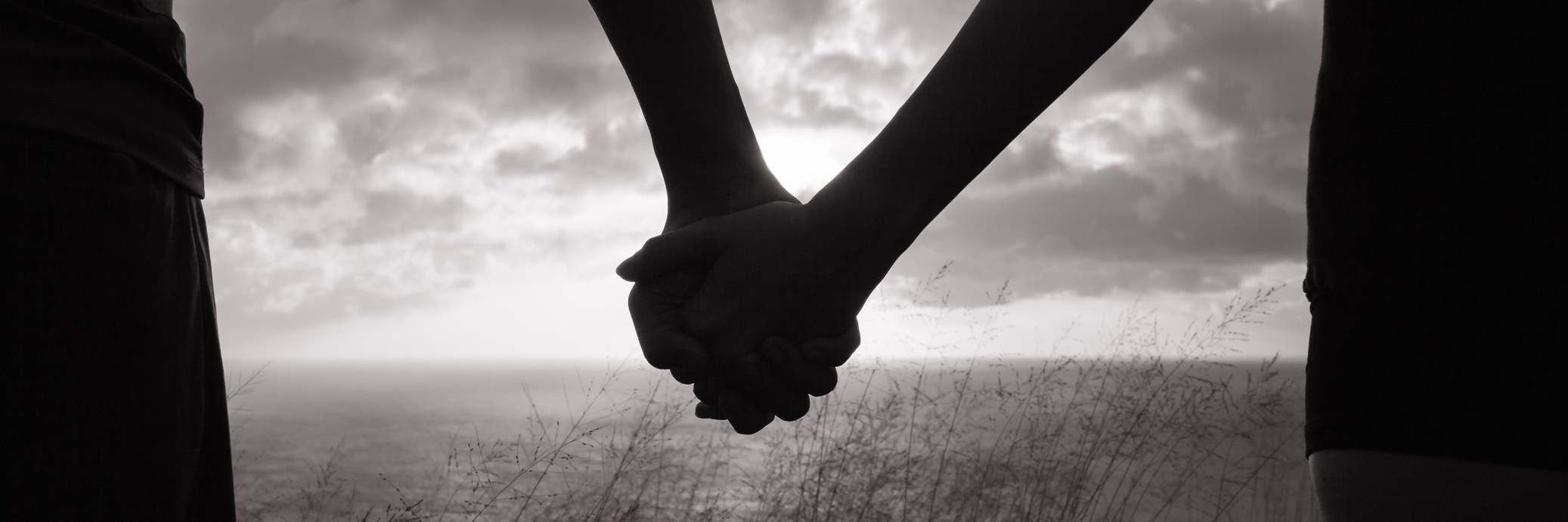 Finding Love After My Husband Died by Suicide Couple holding hands in the sunset