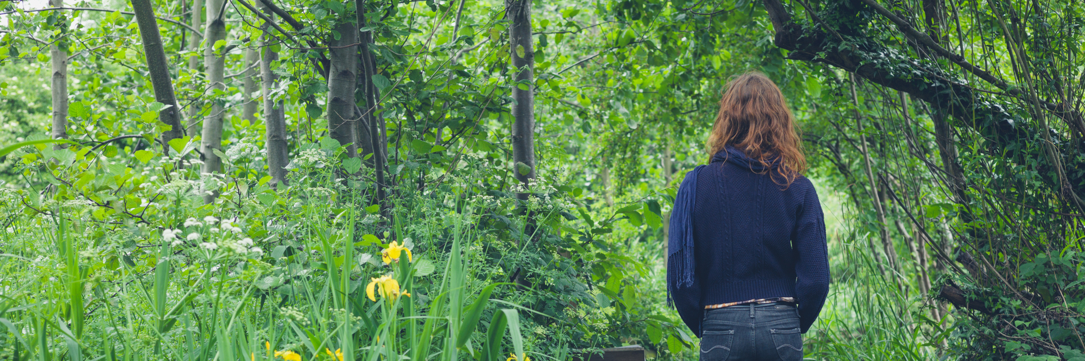 Ways My Cerebral Palsy Affects Me Woman walking on path in forest.