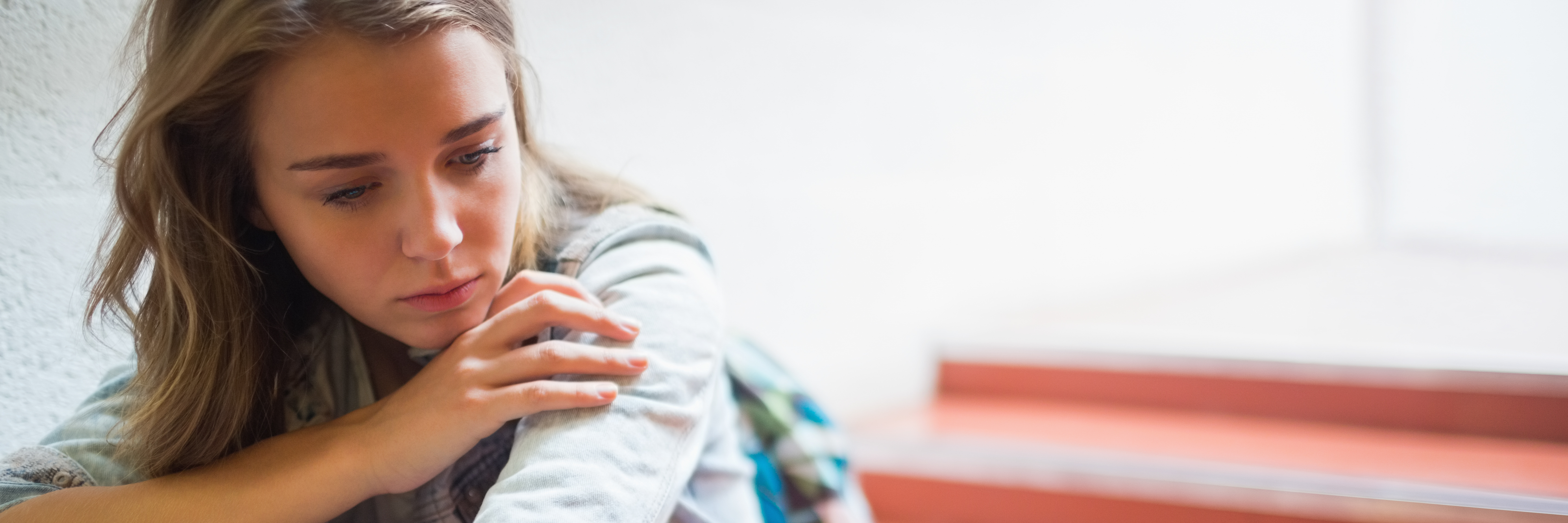 What It's Like to Be a College Student With an Eating Disorder Sad lonely student sitting on stairs