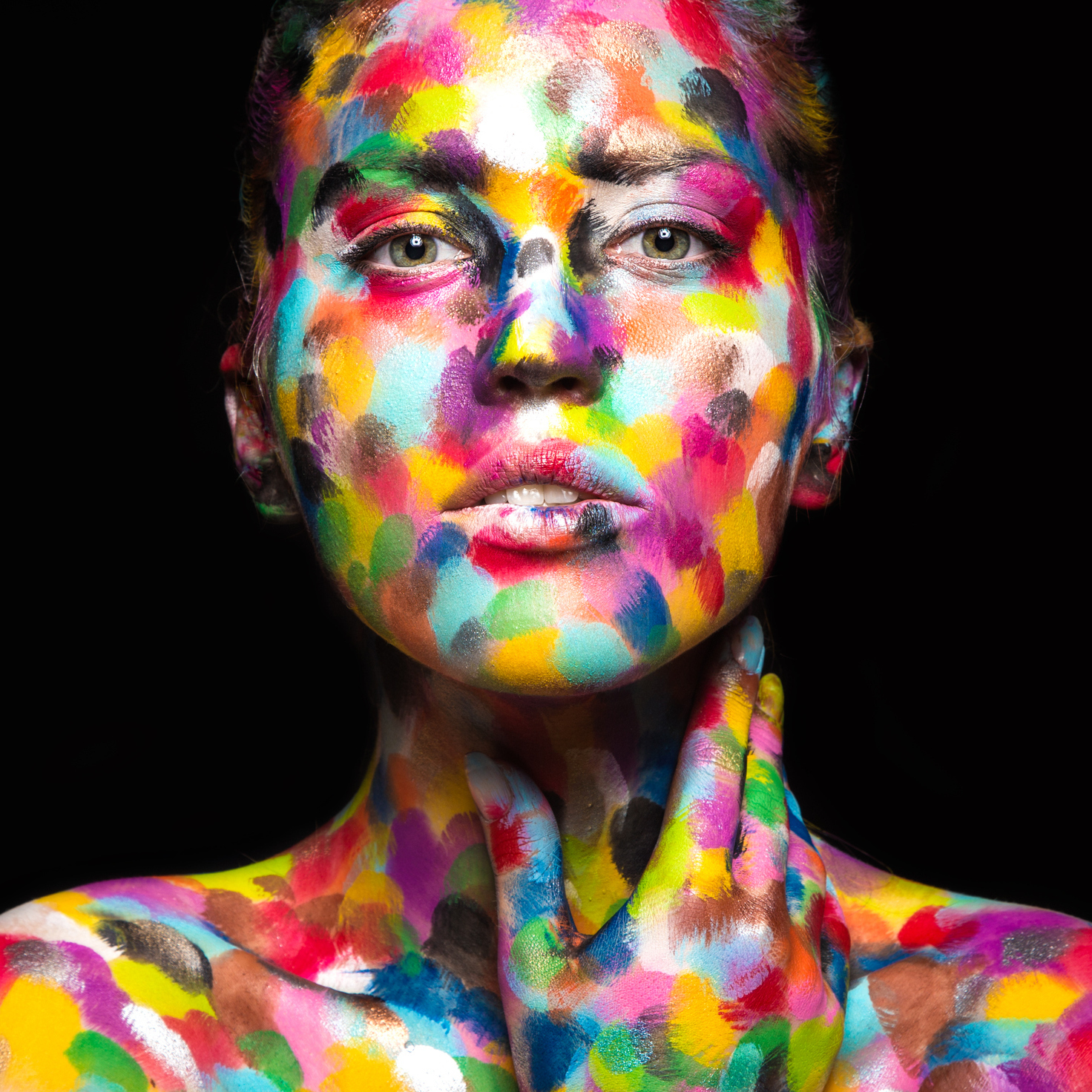 woman with her face painted in multi-colored spots