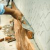 applying mortar in between bricks in a wall
