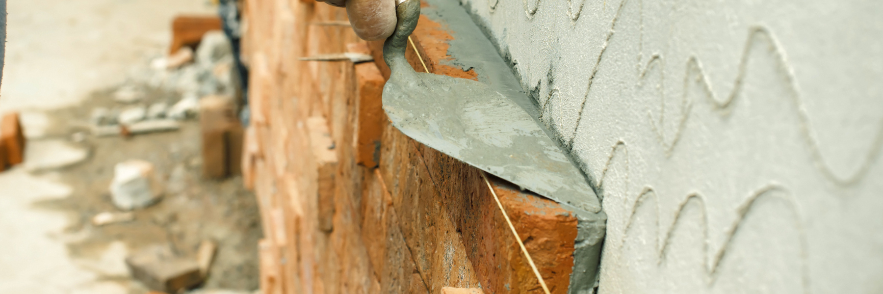 Coping After Surgery, Healing From Chronic Pain and Hypermobility applying mortar in between bricks in a wall