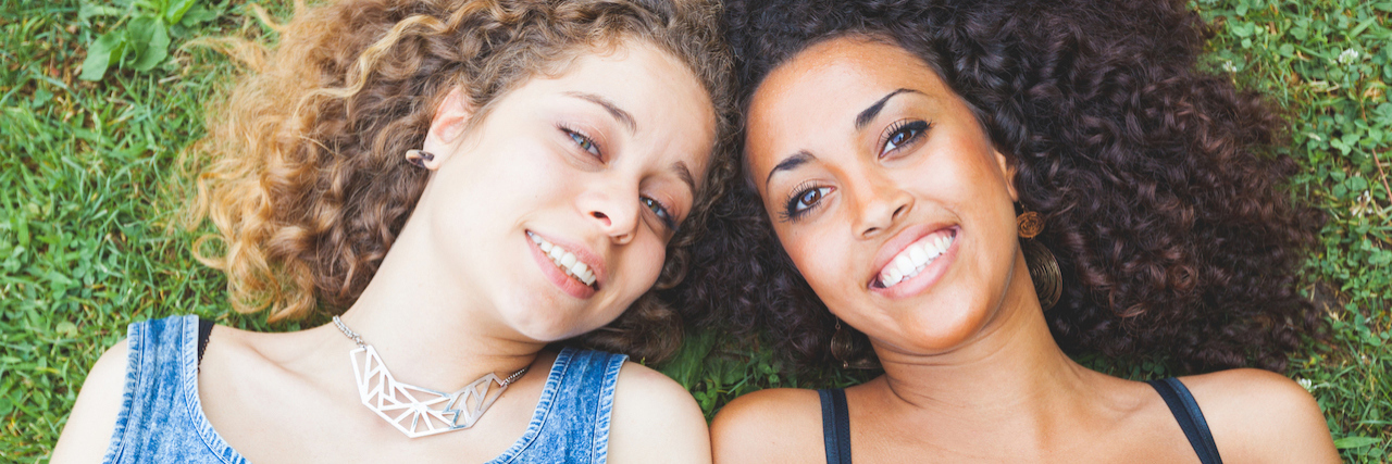 To the Friends Who Stay When I'm Having a Bad Mental Health Day Two woman lying in grass