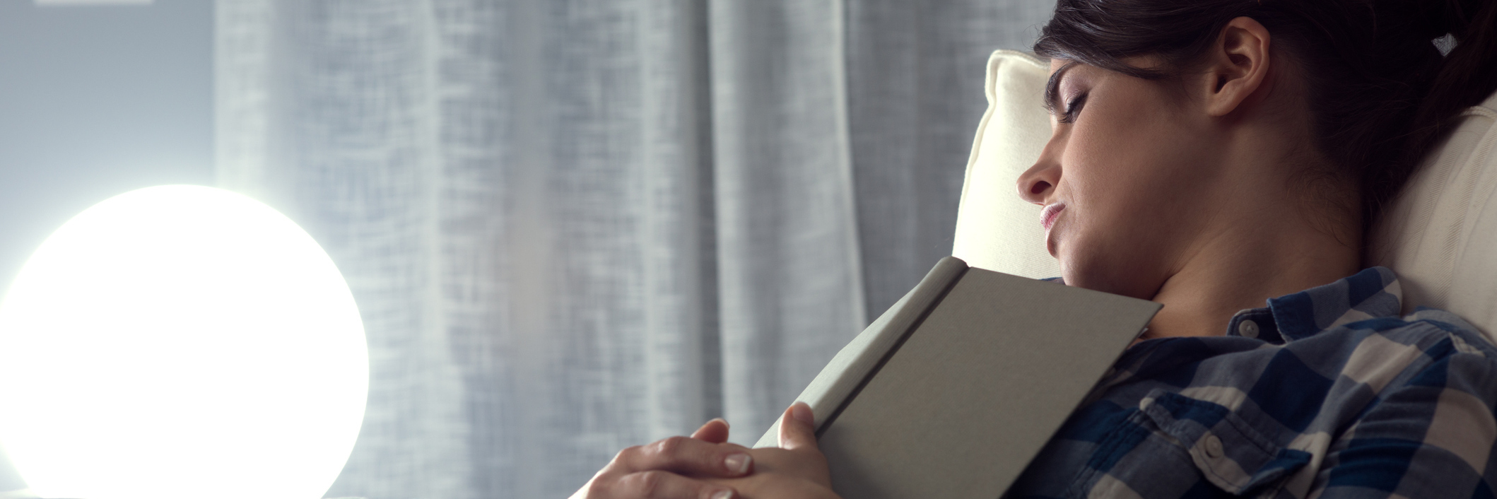 Chronic Pain, Insomnia, Fatigue: Being Teased for Falling Asleep Early woman asleep on her couch with a book open on her chest