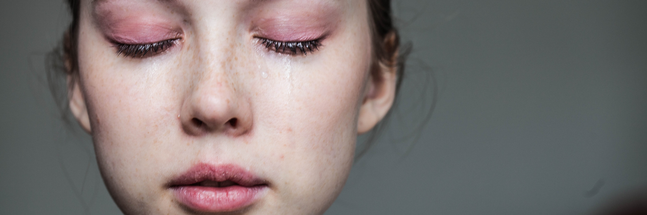 How to Hold Onto Hope When You Have Chronic Pain A woman with her eyes shut, while crying.