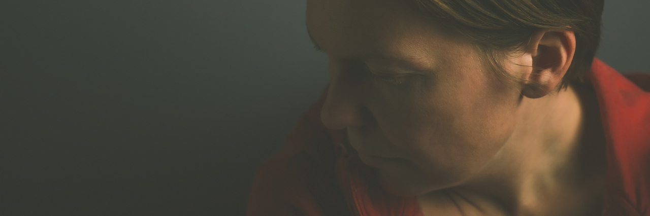 The Difficulty of Grieving When You Already Have Depression A woman in the dark