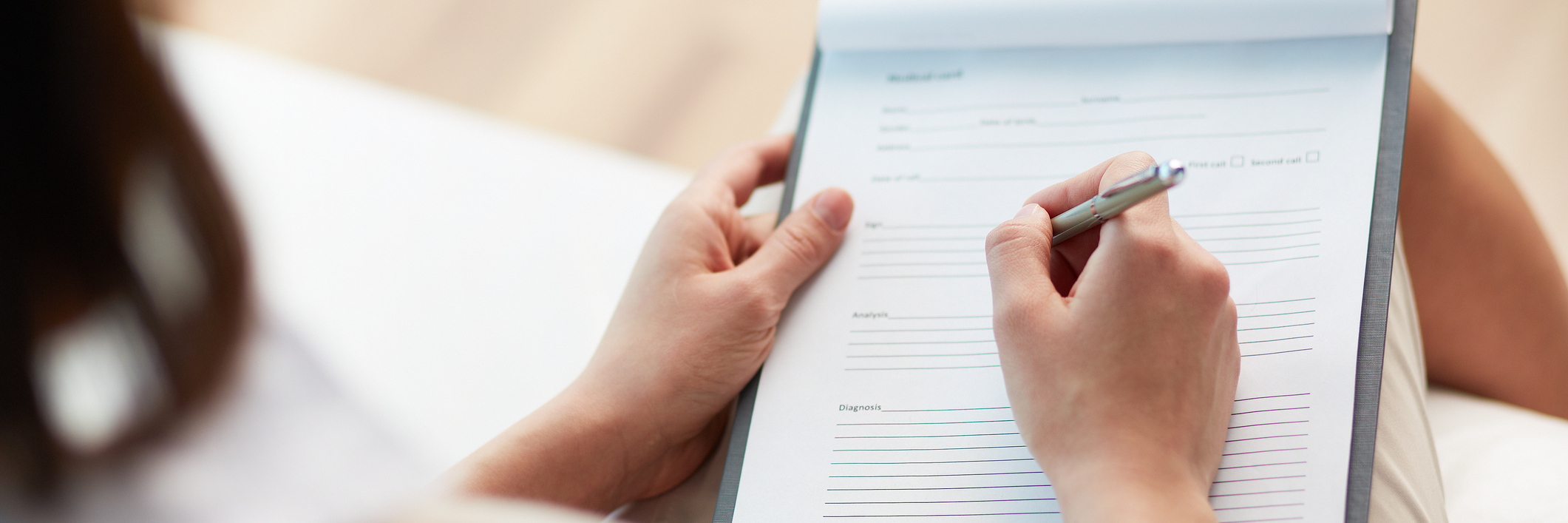 How Doctors Should Treat Patients Who Self-Harm Female counselor writing down some information about her patient