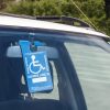 disability parking permit in windshield of a car