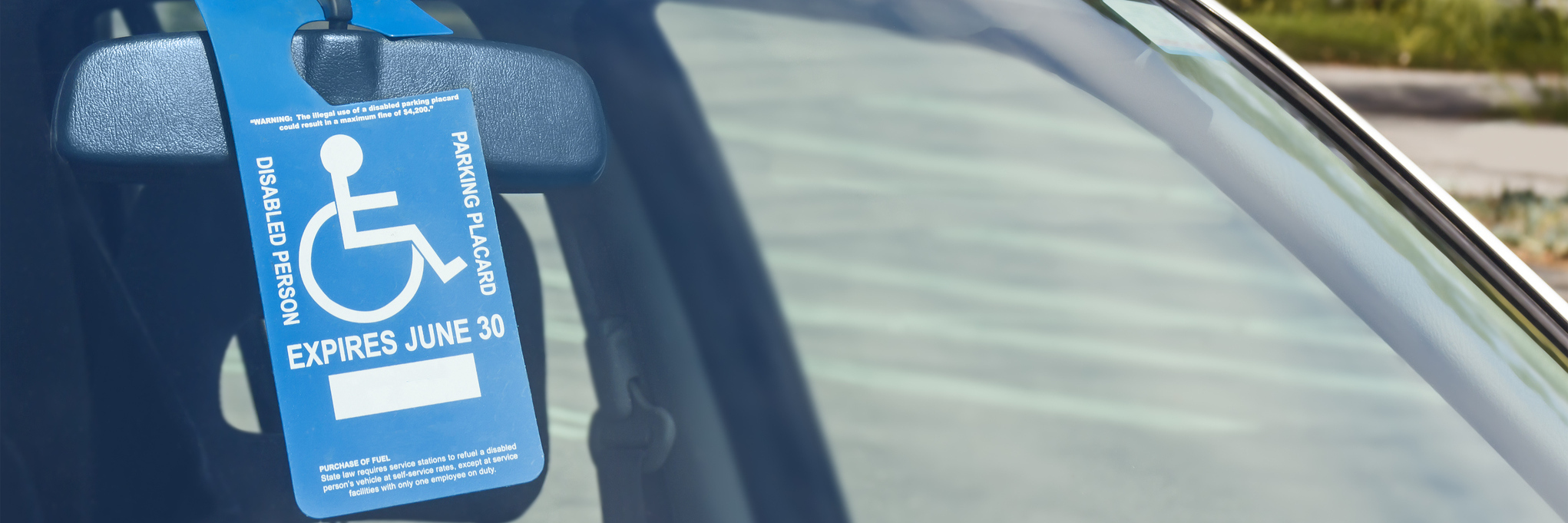 Being Judged for Looking Too Young to Use a Disability Parking Space disability parking permit in windshield of a car