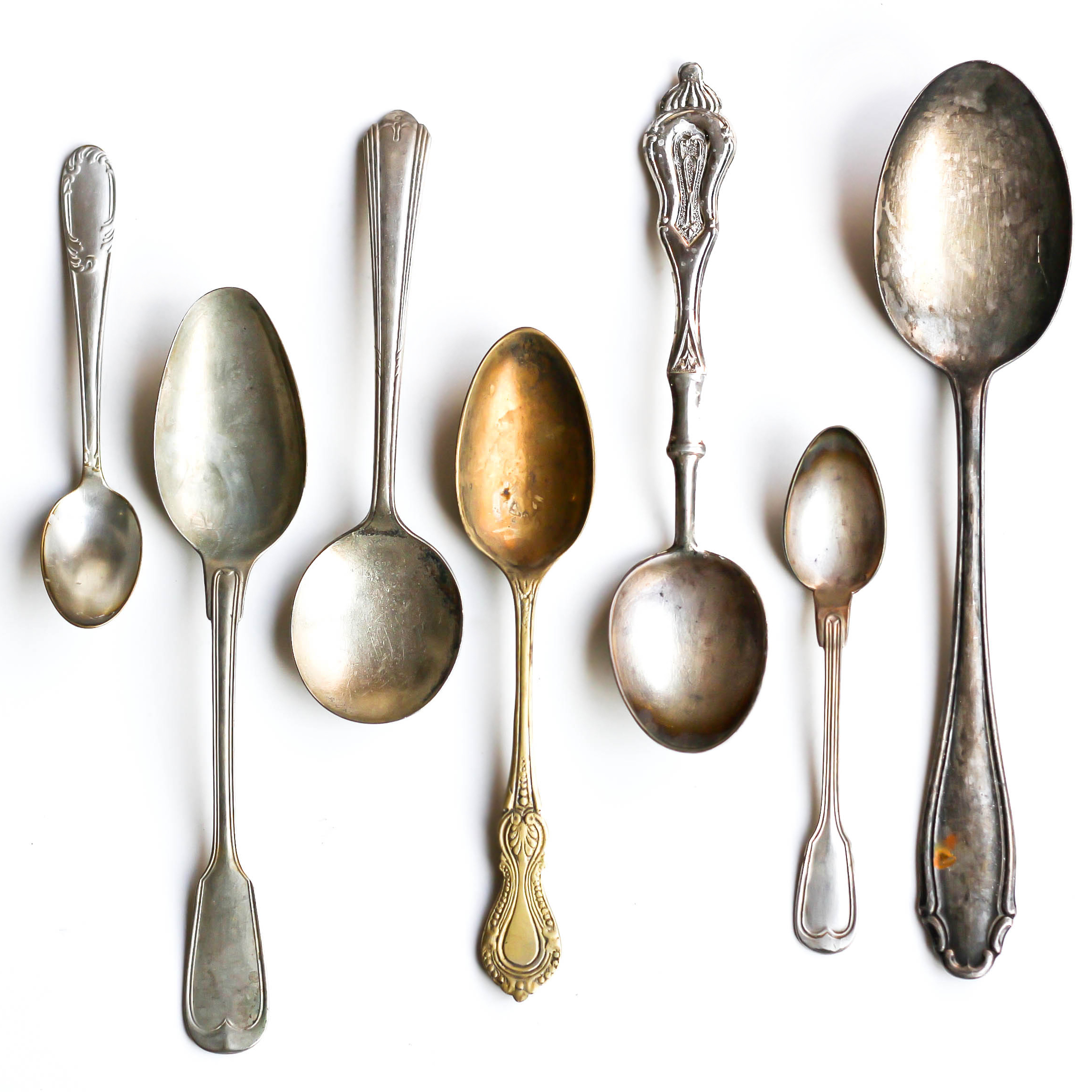 various antique silver spoons