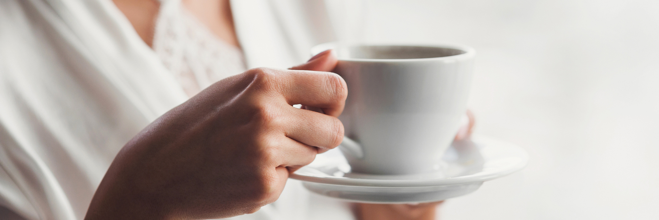 What It Means to 'Successfully' Live With a Mental Illness woman drinking coffee in soft light