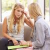 depressed college student talking to counselor of similar age