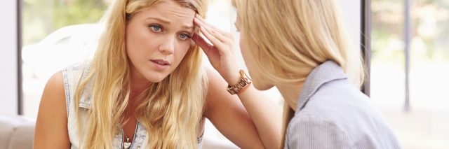 depressed college student talking to counselor of similar age