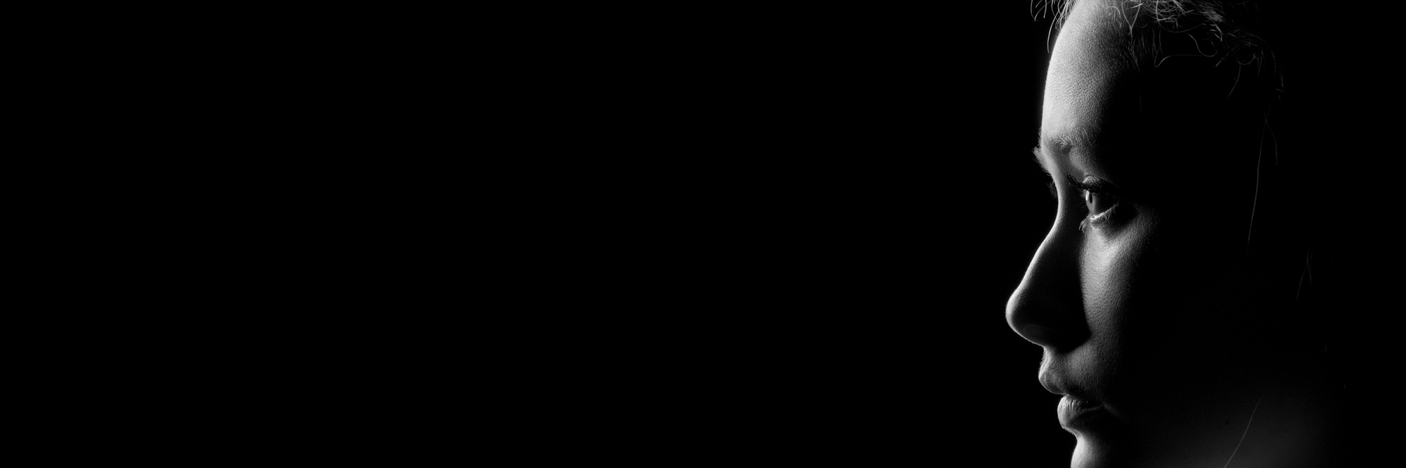 How I'm Challenging 5 Incorrect Eating Disorder Myths in the Media profile of young pensive woman with red hairs on black background with copyspace, monochrome
