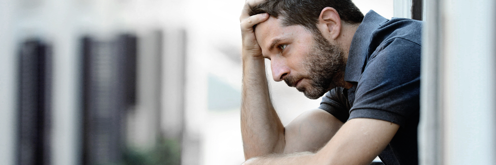 What to Know About Loving Me Regarding My Depression young man standing on balcony with depression