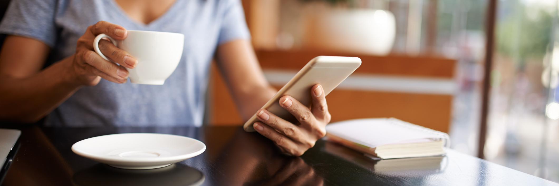 Response to Cyberbullies Targeting People With Chronic Illness woman checking social media on her phone while drinking coffee