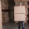 Worker carrying boxes in the warehouse.