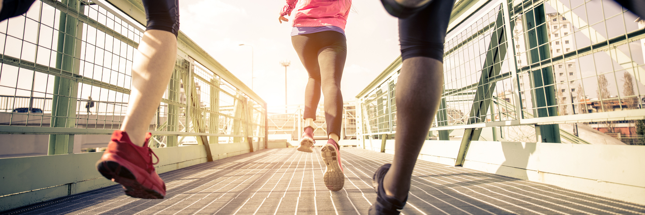 How I've Spent My Life Running From Depression and Anxiety three runners sprinting outdoors along bridge