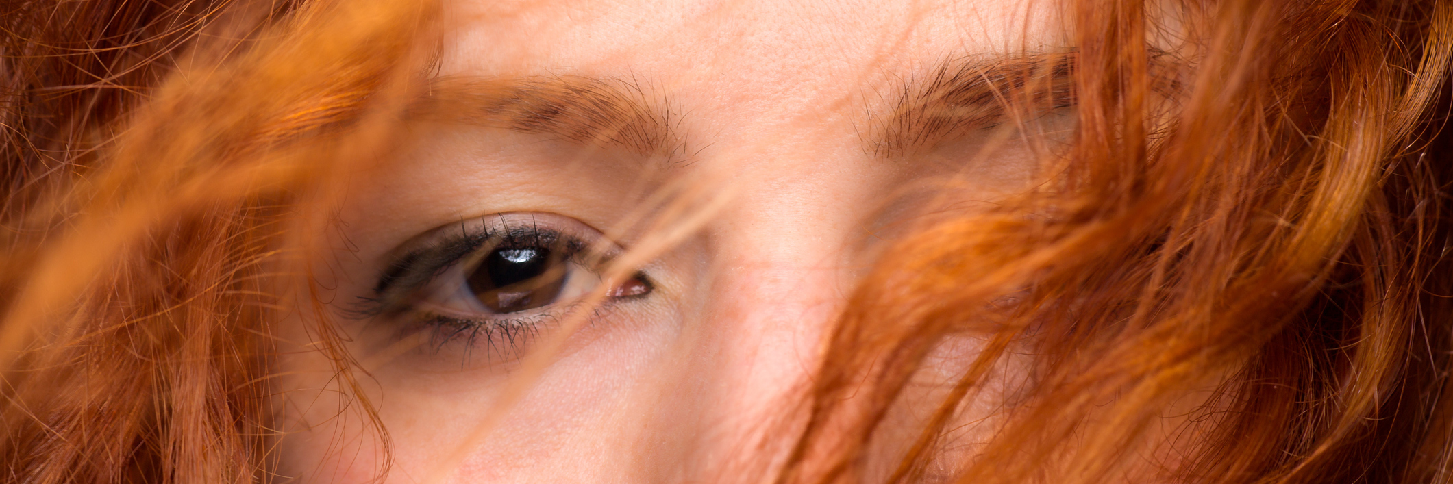7 Ways to Show Compassion to Your Chronically Ill Friends A close-up on a red-headed woman's eyes.