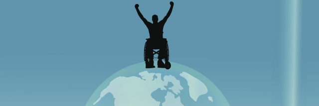 Silhouette of man in wheelchair sitting on top of the world.