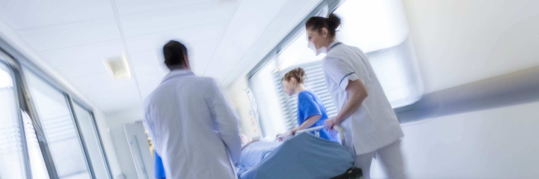 Thank You to ER Staff for Not Judging Me as a Chronic Pain Patient ER staff wheeling a patient on a stretcher