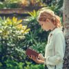 A woman reading a book outside