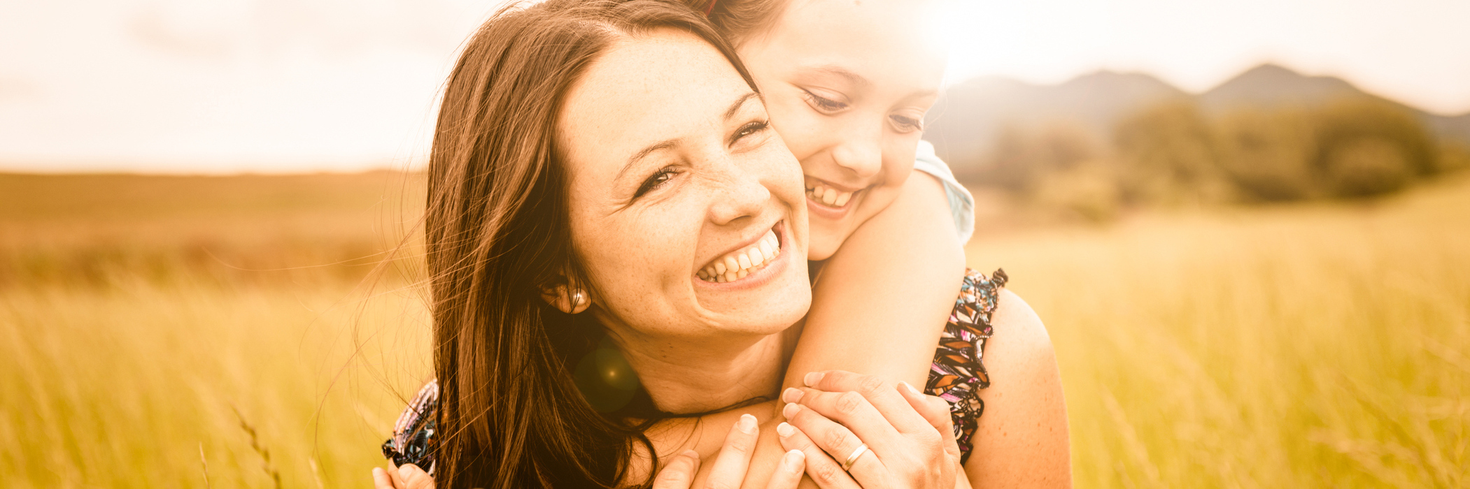 How I Came to Understand My Wonderful, Anxious Daughter mother and daughter hugging in field smiling
