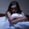 woman sitting in bed at night